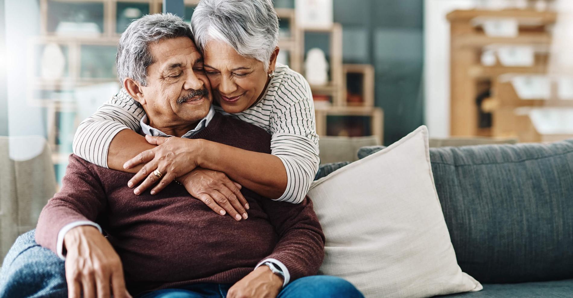 woman hugging man on couch